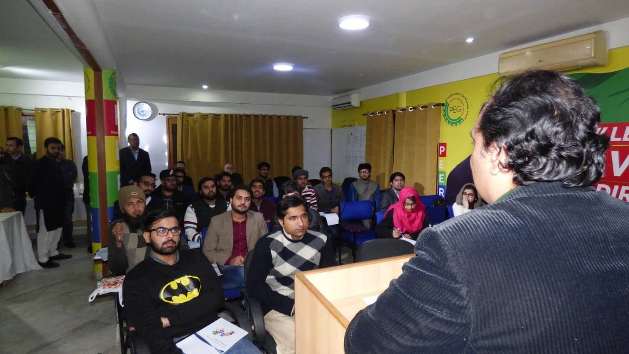 A speaker addresses an audience of young engineers in a seminar room during YPEG's first training session on hydropower projects.