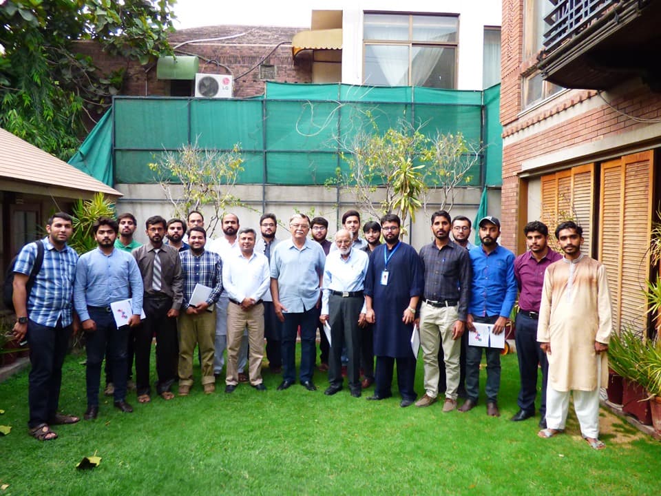 Participants of the PEG training on the mechanics of rocks posing for a group photo on a lawn.