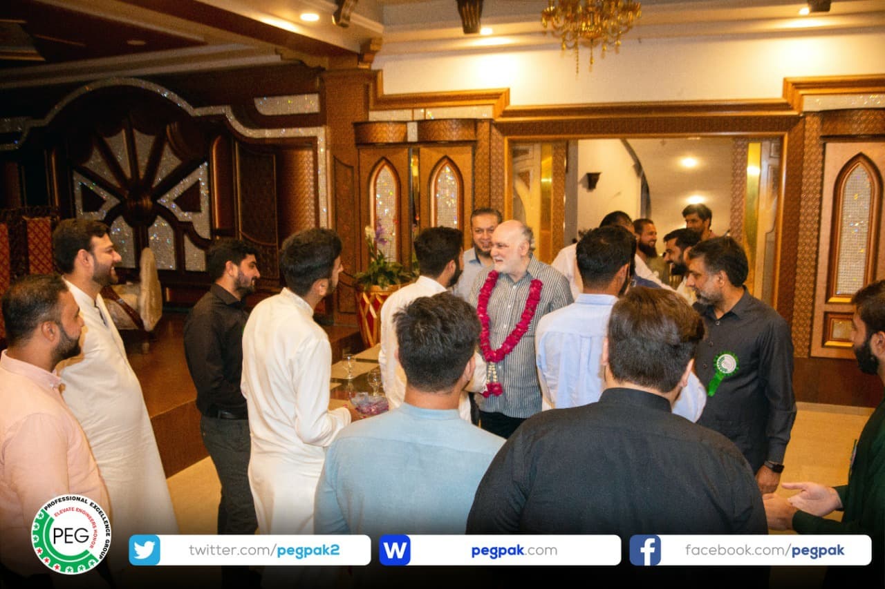 Engr. Waseem Nazir, wearing a floral garland, greeted by engineers at a corner meeting in Gujranwala.