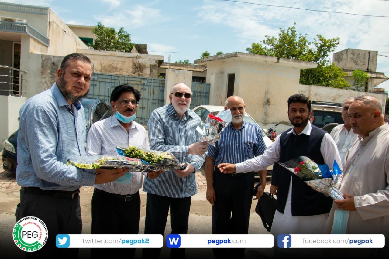 Engr. Waseem Nazir being presented with flowers and a traditional shawl by engineers in Mirpur, Azad Kashmir.