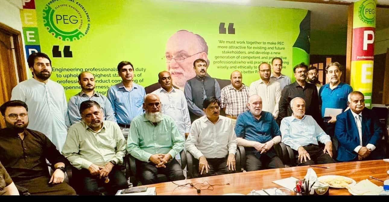 PEG members and coordinators posing in front of a green PEG backdrop after the hybrid meeting on the PEC elections 2024.